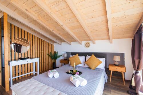 a bedroom with a bed with towels on it at Blue sky loft by Corfuescapes in Spartýlas