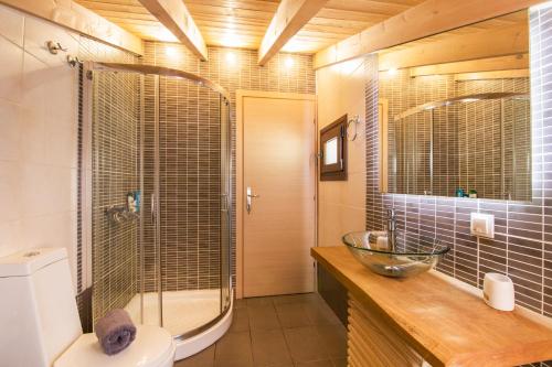 a bathroom with a glass shower and a toilet at Blue sky loft by Corfuescapes in Spartýlas
