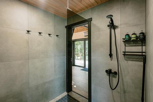a bathroom with a shower and a glass door at Tindioru Valley Resort in Rõuge