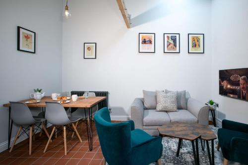 a living room with a table and a couch at Accommodation at Salomons Estate in Royal Tunbridge Wells