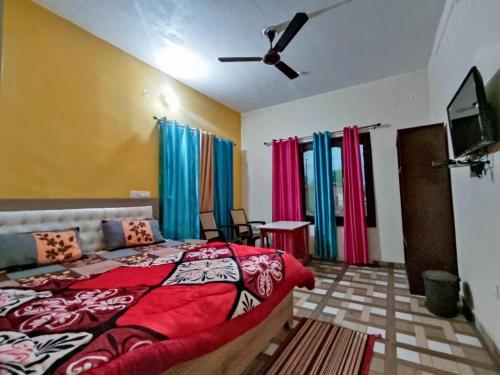 a bedroom with a bed and a ceiling fan at Shree Om Nanda Rudra Hotel Chaukori Pithoragarh in Chaukori