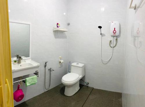 een badkamer met een douche, een toilet en een wastafel bij A Cool place to stay in Seremban