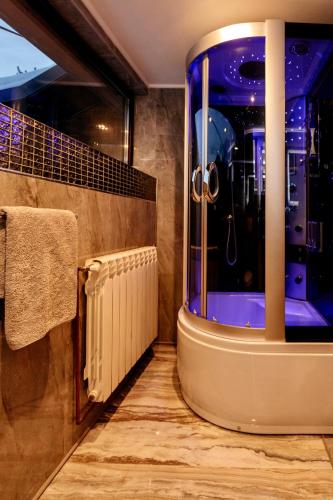 a bathroom with a shower with a large window at VIP Villa & Spa in Colibiţa