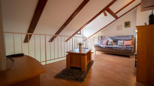 a living room with a couch and a table at Specious Apartment Manitu in forest countryside in Fužine