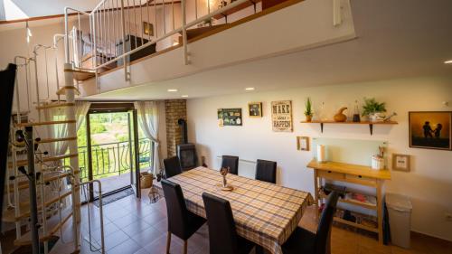 a kitchen and dining room with a table and chairs at Specious Apartment Manitu in forest countryside in Fužine