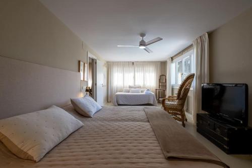 a hotel room with a bed and a television at Torre Lolita - House in Lleida for 8 with pool and tennis court in Lleida