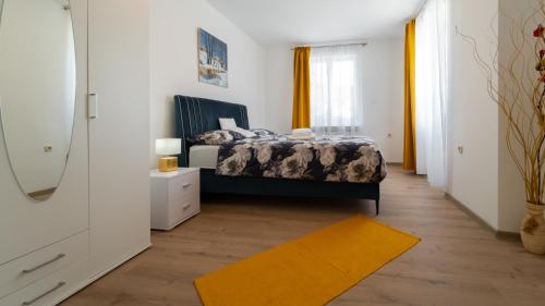 a bedroom with a bed and a yellow rug at Dvije lipe in Moravice