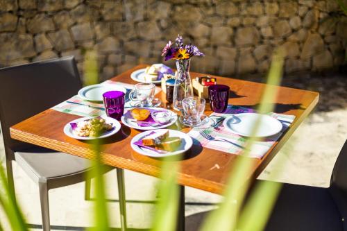a wooden table with plates of food on it at Agriturismo Giannavi in Palazzolo Acreide