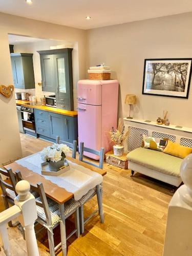 a kitchen with a table and a pink refrigerator at City Apartments - 66 Scott Street in York