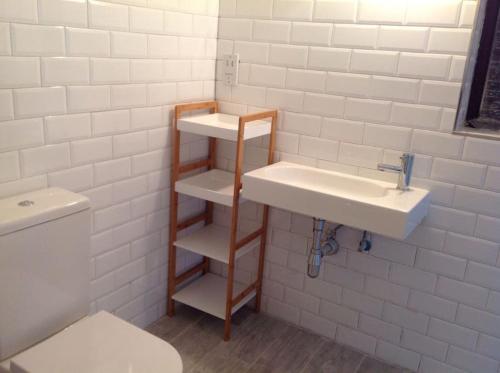 a bathroom with a sink and a toilet at Seafront, 2 bed apartment in quiet central area in Pembroke