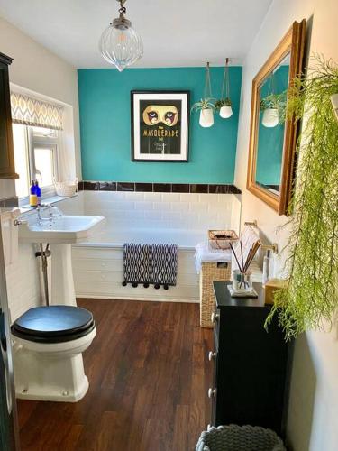 a bathroom with a toilet and a sink and a tub at City Apartments - 66 Scott Street in York
