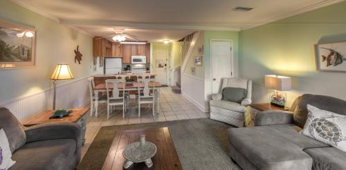 a living room with a couch and a dining room at Villas by the Sea Resort & Conference Center in Jekyll Island