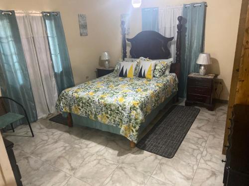 a bedroom with a bed with a floral bedspread at Murray's Cool Spot in Mandeville
