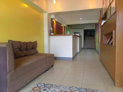 a living room with a couch and a counter at Mansion 8 Residences in Roxas City