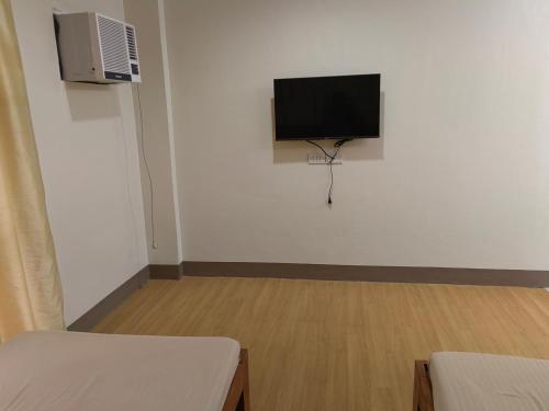 a room with a flat screen tv on a wall at Mansion 8 Residences in Roxas City
