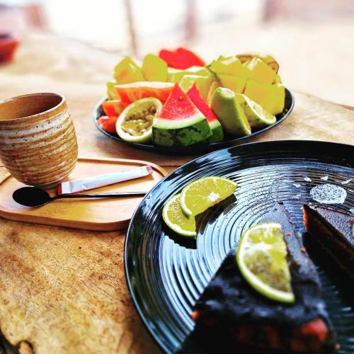 two plates of fruit on a wooden table at Boho Boutique Hotel - Beachfront , Adults Only , Private Pool in Kiwengwa