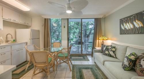 a kitchen and living room with a couch and a table at Villas by the Sea Resort & Conference Center in Jekyll Island