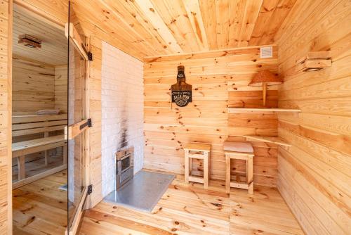 a log cabin with a clock on the wall at Dom Na Skraju Mazur in Olsztyn