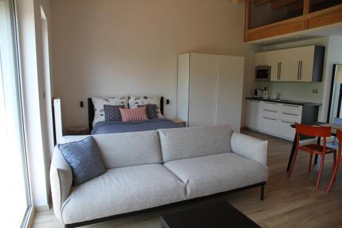 a living room with a couch and a bed at Apartmány Hluboká nad Vltavou s výhledem na zámek in Hluboká nad Vltavou