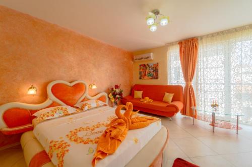 a bedroom with a large bed with a heart shaped headboard at Boutique Guest House 'Sofia' in Nesebar