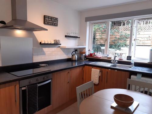 a kitchen with a table and a counter top at Castlefield Cosy Cottage in Cupar