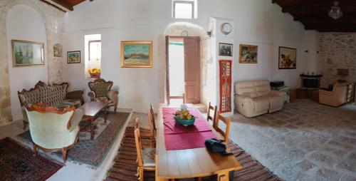 a living room with a table and a couch at Agriturismo Giannavi in Palazzolo Acreide