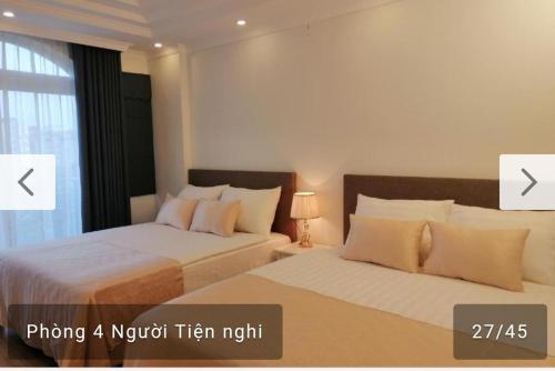 a bedroom with two beds and a window at Căn hộ Sao Mai - Nội Bài Hà Nội in Hanoi