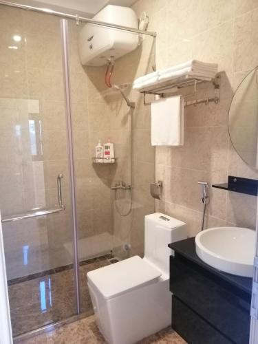 a bathroom with a shower and a toilet and a sink at Căn hộ Sao Mai - Nội Bài Hà Nội in Hanoi