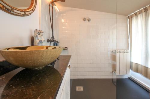 a bathroom with a bowl sink on a counter at Luxury villa in El Sardinero in Santander