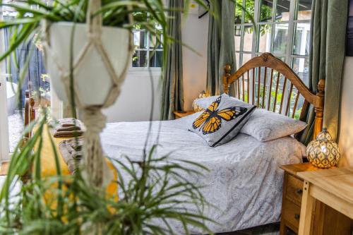 a bedroom with a bed with a butterfly pillow on it at Garden Studio in Williton