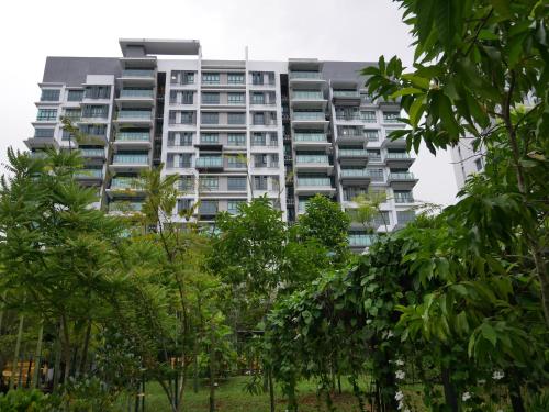 a tall apartment building with trees in front of it at Jome Putrajaya Presint 8 Natural Homestay in Putrajaya