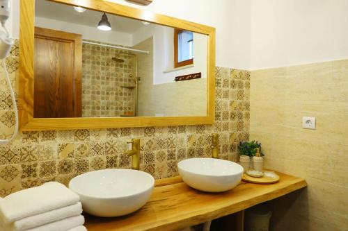 a bathroom with two sinks and a mirror at AMA Guest House in Turda