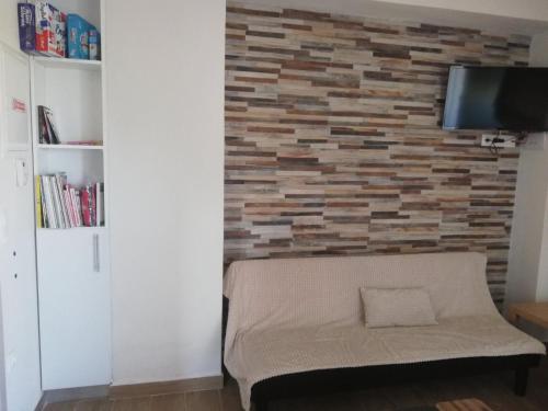 a living room with a brick accent wall at Stbs Luxury, Nea Fokea in Nea Fokea