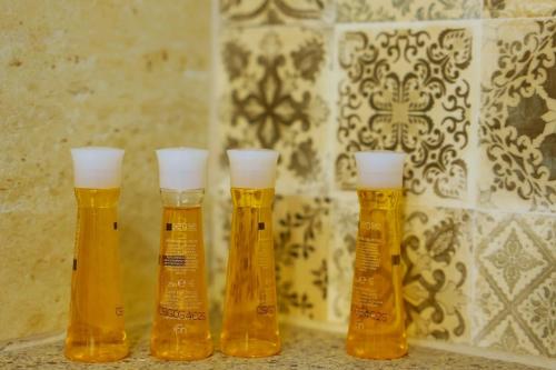 a group of four bottles of beer sitting on a counter at AMA Guest House in Turda