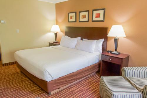 a hotel room with a bed and a couch at First Choice Inn at the Swell in Green River