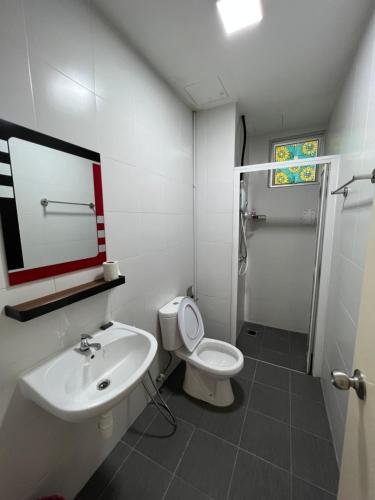 a bathroom with a toilet and a sink and a shower at Home Away From Home In Taiping - Newly Upgraded! in Taiping