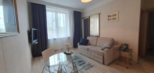 a living room with a couch and a glass table at Better Place Varso Center in Warsaw