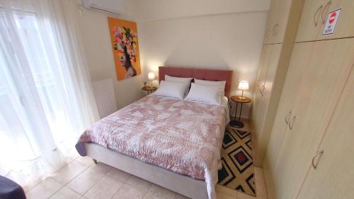 a bedroom with a large bed with two pillows at PORTO D'ORO LUXURY APARTMENT in Lávrion