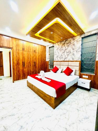 a bedroom with a large bed with a red blanket at Dreamville Stays Shimla - Luxury Homestay and B&B in Shimla