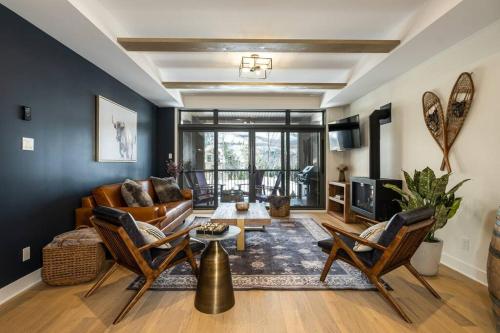 a living room with a couch and a table at Tremblant Prestige - Verbier 10-104 in Mont-Tremblant