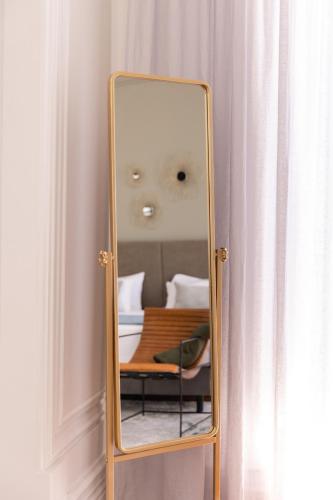 a mirror sitting on a stand in a room at Quinta dos Tojais Hotel Rural in Celorico de Basto