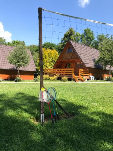 two tennis rackets and a net in a yard at Domki u Oli in Kudowa-Zdrój