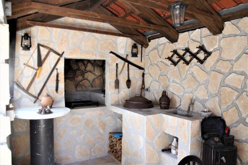 uma cozinha com paredes de pedra e um forno de pedra em Apartments Dvije Palme em Šibenik