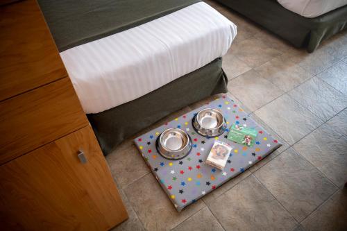 a bed with a tray of food on a mat next to a beduteneway at Vilar Rural De Sant Hilari Sacalm by Serhs Hotels in Sant Hilari Sacalm