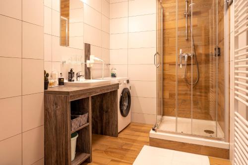 a bathroom with a sink and a shower at Apartmán Mendy in Liptovský Ján