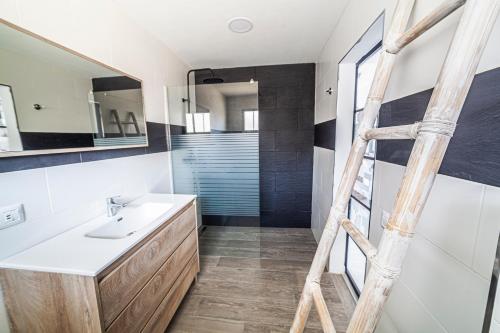 bagno con lavandino e scala in legno di Amazing Luxury Apartment, La Casa del Corazon a Morro del Jable
