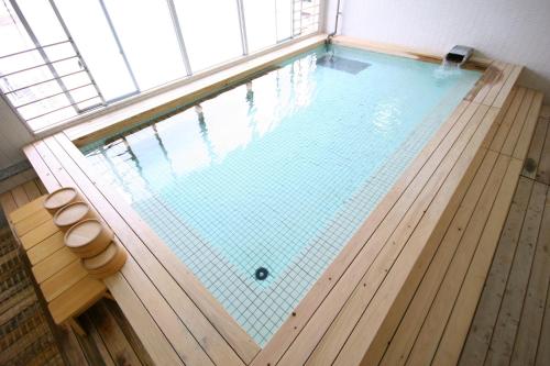 an indoor swimming pool in a building at Wasuki Tsukasakan in Kumamoto