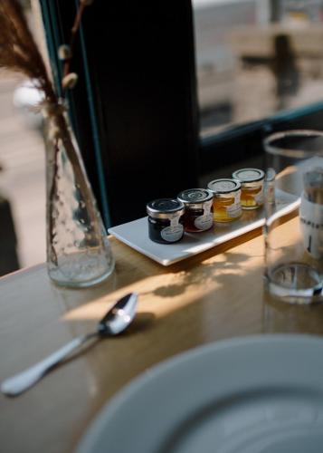 a counter with a sink and a plate with jars of honey at Hebden Townhouse in Hebden Bridge