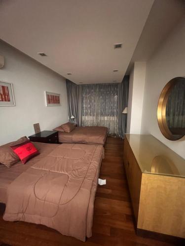 a hotel room with two beds and a large window at Cosway Residence near Pavilion KL in Kuala Lumpur