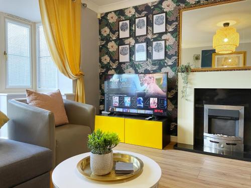 sala de estar con TV y chimenea en Mayflower House Barnsley-Wombwell-3 Bedrooms-2 Showers-Longer Stay- Free Parking, en Barnsley